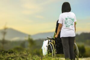A person in a wheelchair and their caregiver look out over mountains. elder care caregiving hospice questions answered